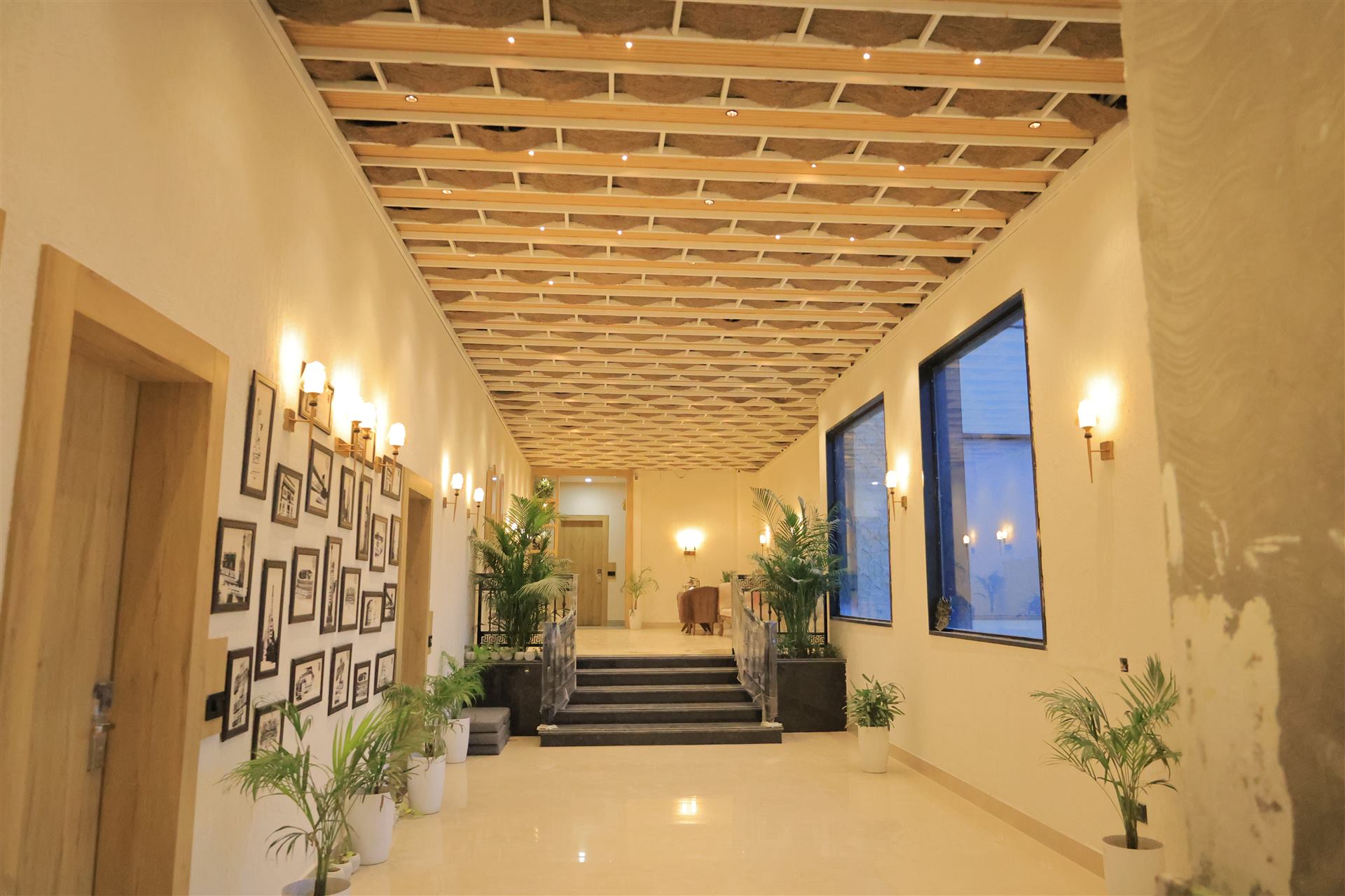 Hallway with woven timber ceiling and staircase