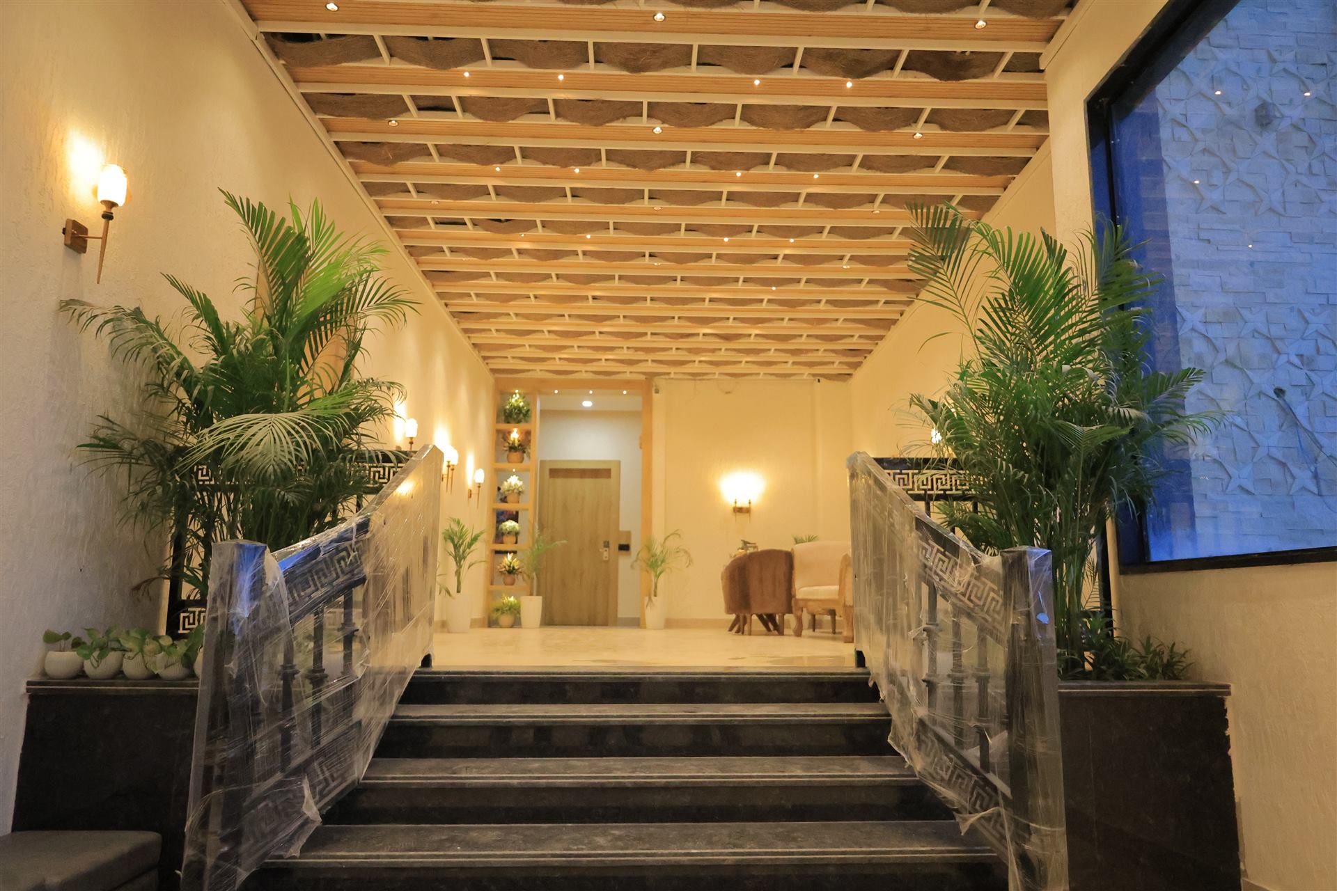 Hallway with planters leading to stairs