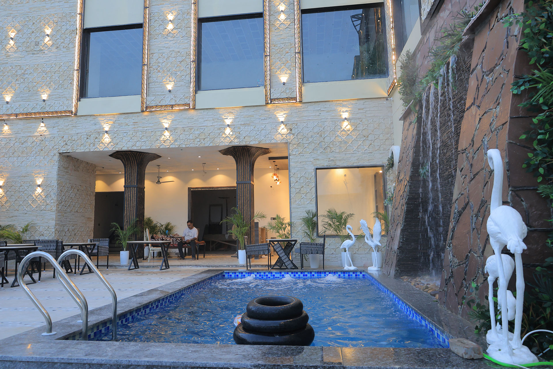 Stone waterfall wall beside the pool