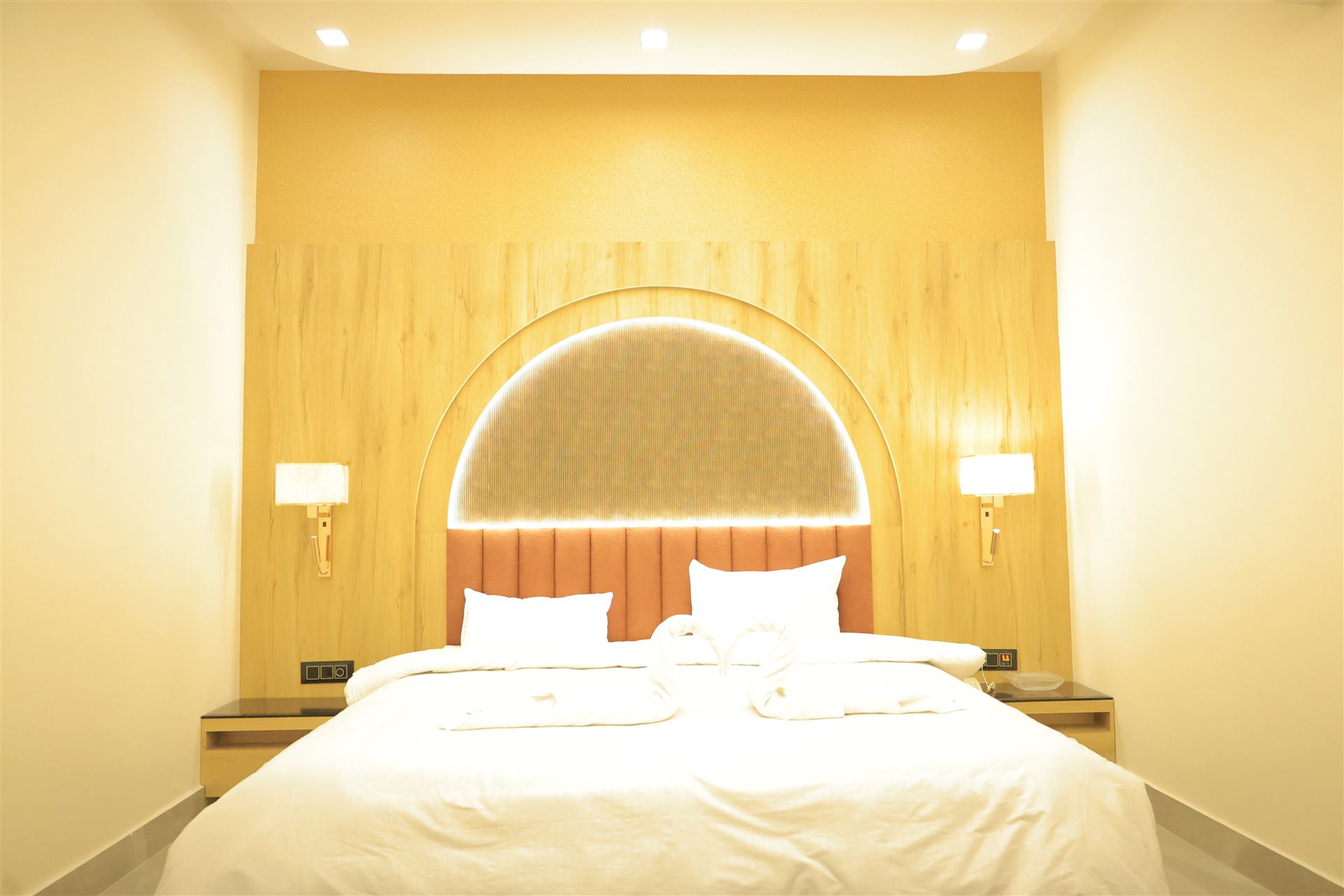 Solstice Room with arched wood headboard